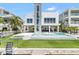 This modern waterfront home has a swimming pool, a boat dock, and an elevator shaft to a rooftop deck at 905 Bay Point Dr, Madeira Beach, FL 33708