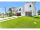 This waterfront home features a garage, artificial turf, and a covered outdoor area under the home at 905 Bay Point Dr, Madeira Beach, FL 33708