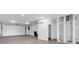 Spacious garage with tiled floors, elevator and ample room for multiple vehicles at 905 Bay Point Dr, Madeira Beach, FL 33708