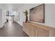 Bright hallway featuring tiled floors, stylish decor, and a staircase in the background at 905 Bay Point Dr, Madeira Beach, FL 33708