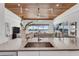 Modern kitchen with sleek countertops and open layout overlooking the living area and waterfront views at 905 Bay Point Dr, Madeira Beach, FL 33708