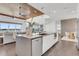 Modern kitchen island featuring stainless steel appliances, quartz countertops, and sleek white cabinetry at 905 Bay Point Dr, Madeira Beach, FL 33708