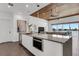 Modern kitchen featuring stainless steel appliances, quartz countertops, and sleek white cabinetry at 905 Bay Point Dr, Madeira Beach, FL 33708
