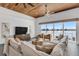 Bright living room featuring water views, modern furnishings and a unique wood plank ceiling with fan at 905 Bay Point Dr, Madeira Beach, FL 33708