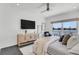 Comfortable main bedroom featuring water view, ceiling fan, and modern furnishings at 905 Bay Point Dr, Madeira Beach, FL 33708