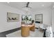 Bright home office with a unique wooden desk, modern decor, and a ceiling fan at 905 Bay Point Dr, Madeira Beach, FL 33708