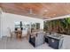 This covered outdoor space features a wood ceiling, recessed lighting, ceiling fans, and comfortable seating at 905 Bay Point Dr, Madeira Beach, FL 33708