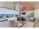 Covered outdoor patio with ceiling fans, outdoor seating and inter coastal waterway view at 905 Bay Point Dr, Madeira Beach, FL 33708