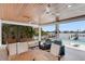 Covered outdoor patio with ceiling fans, outdoor seating and inter coastal waterway view at 905 Bay Point Dr, Madeira Beach, FL 33708