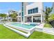 This waterfront home has a swimming pool, a hot tub, an outdoor kitchen, and an elevator shaft to a rooftop deck at 905 Bay Point Dr, Madeira Beach, FL 33708