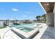 Backyard swimming pool and spa with dock and boat in the inter coastal waterway at 905 Bay Point Dr, Madeira Beach, FL 33708