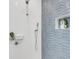 The stylish shower in the bathroom has custom design tiles at 905 Bay Point Dr, Madeira Beach, FL 33708