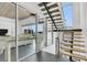 Modern staircase features floating wood steps, glass windows with water views, and sleek metal accents at 905 Bay Point Dr, Madeira Beach, FL 33708
