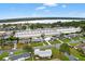 An aerial view showcases the neighborhood, nearby lake, and commercial areas in the distance at 9120 108Th St, Seminole, FL 33772