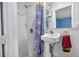 Small bathroom including a shower, sink, and mirror with bright paint and decor at 9120 108Th St, Seminole, FL 33772