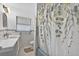 Well-lit bathroom with a decorative shower curtain and plenty of counter space at 9120 108Th St, Seminole, FL 33772