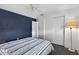 Stylish bedroom with a ceiling fan, blue accent wall, closet, and soft carpet flooring at 9120 108Th St, Seminole, FL 33772
