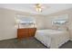 Cozy bedroom with a ceiling fan, dresser, and large windows for natural light at 9120 108Th St, Seminole, FL 33772