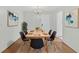 Well-lit dining room showcasing hardwood floors, a dining table set for six, and stylish artwork at 9120 108Th St, Seminole, FL 33772