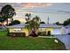 Charming yellow single story home with a well maintained lawn, attractive front yard landscaping, and a single car garage at 9120 108Th St, Seminole, FL 33772