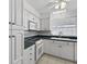 Well-maintained kitchen with white cabinetry, modern appliances, and a breakfast bar for casual dining at 9120 108Th St, Seminole, FL 33772