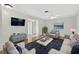 Cozy living room featuring hardwood floors, comfortable seating, and a modern television at 9120 108Th St, Seminole, FL 33772