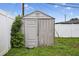 Backyard shed with adjacent shrubbery and a partial view of the home's fence at 9120 108Th St, Seminole, FL 33772
