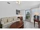 Cozy sunroom with a couch, coffee table, and an exterior exit at 9120 108Th St, Seminole, FL 33772