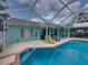 Backyard boasts a covered patio with outdoor seating, a pool, and lush greenery, creating an inviting outdoor space at 920 Tuscanny St, Brandon, FL 33511