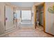 Bright bathroom with a glass-enclosed shower and a separate tub with glass block window at 920 Tuscanny St, Brandon, FL 33511