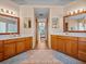 Large bathroom with double vanities, tile floors, and access to shower/tub at 920 Tuscanny St, Brandon, FL 33511