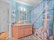 Bathroom with blue walls, tile floors, a shower/tub combo, pink vanity, and nautical decor at 920 Tuscanny St, Brandon, FL 33511