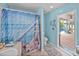 Bathroom with blue walls, a shower/tub combo, tile floors and an open view to a pool area at 920 Tuscanny St, Brandon, FL 33511