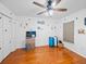 Well lit bedroom featuring wood floors, ceiling fan, closet, and cartoon character decor at 920 Tuscanny St, Brandon, FL 33511