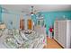 Bright bedroom with wood floors, ceiling fan, TV and tropical-themed decor at 920 Tuscanny St, Brandon, FL 33511