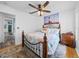 Cozy bedroom with wood-look floors, ceiling fan, a decorative bed frame and a lighthouse picture at 920 Tuscanny St, Brandon, FL 33511