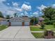 Charming single-story home with a well-manicured lawn, mature trees and a three car garage at 920 Tuscanny St, Brandon, FL 33511