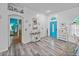 Bright foyer featuring driftwood-style flooring, a vibrant blue door, and decorative nautical decor at 920 Tuscanny St, Brandon, FL 33511