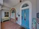 Welcoming front porch with colorful accents, stained glass and a stylish blue door at 920 Tuscanny St, Brandon, FL 33511