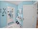 Hallway with blue walls, tile floors, and a view of an enclosed outdoor living area with pool at 920 Tuscanny St, Brandon, FL 33511