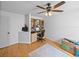 Bright home office featuring custom built-ins, neutral paint, wood floors, and a ceiling fan at 920 Tuscanny St, Brandon, FL 33511