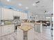 Modern kitchen with stainless steel appliances, stone countertops, an island, and wood look floors at 920 Tuscanny St, Brandon, FL 33511