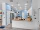 Open kitchen with stainless steel appliances, stone countertops, an island, breakfast bar, and wood look floors at 920 Tuscanny St, Brandon, FL 33511