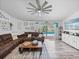 Bright living room featuring a large sectional sofa, a ceiling fan, and sliding glass doors to the pool area at 920 Tuscanny St, Brandon, FL 33511