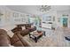 Open-concept living room with coastal decor, a ceiling fan, and views of the backyard pool at 920 Tuscanny St, Brandon, FL 33511
