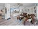 Living room with driftwood flooring, a sectional sofa, and an open layout to the kitchen and dining area at 920 Tuscanny St, Brandon, FL 33511