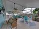 Outdoor bar with multiple seating areas, ceiling fans, TV, and vibrant decor, ideal for entertaining at 920 Tuscanny St, Brandon, FL 33511