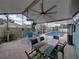 Inviting screened patio with ceiling fans overlooking a sparkling pool with a colorful, decorative dining table at 920 Tuscanny St, Brandon, FL 33511