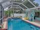 A screened-in pool area with a covered patio and outdoor furniture, perfect for relaxation and entertainment at 920 Tuscanny St, Brandon, FL 33511