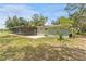 Exterior view of the home featuring the screened patio and ample backyard space at 9819 Allen Rd, Lithia, FL 33547